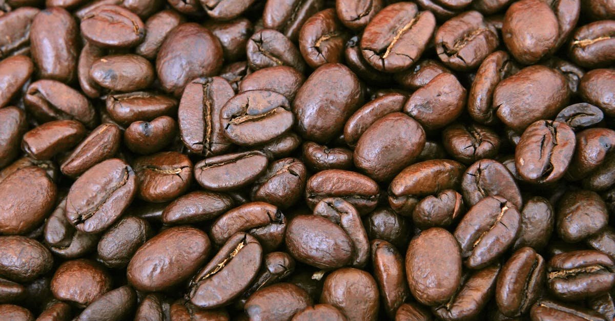 A close-up shot of shiny roasted coffee beans, perfect for caffeine lovers.
